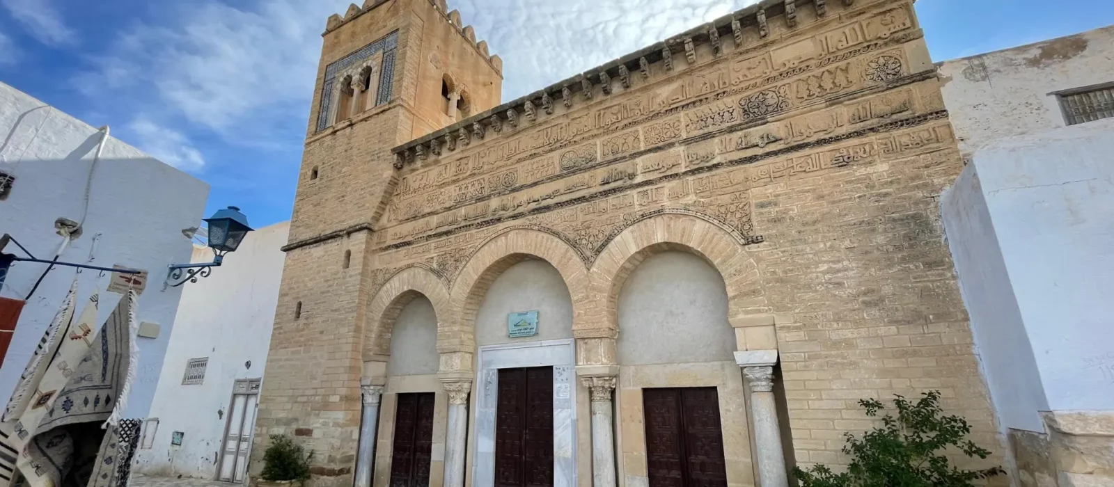 The restored façade of the Mosque of Three Doors in Kairouan after renovations in 1974, preserving its historical and architectural integrity.