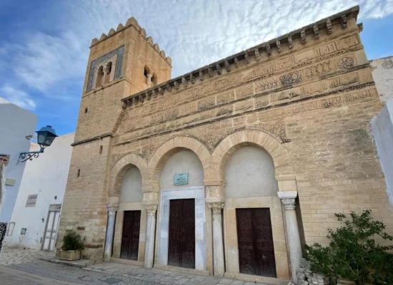 The restored façade of the Mosque of Three Doors in Kairouan after renovations in 1974, preserving its historical and architectural integrity.